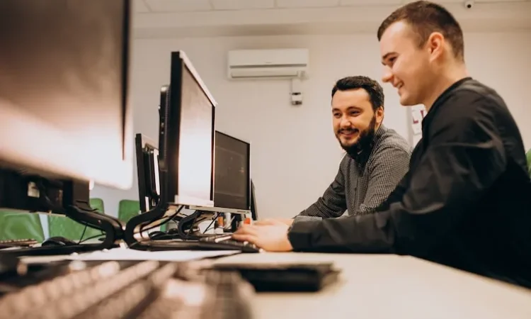 young-male-web-designers-working-computer_1303-19453